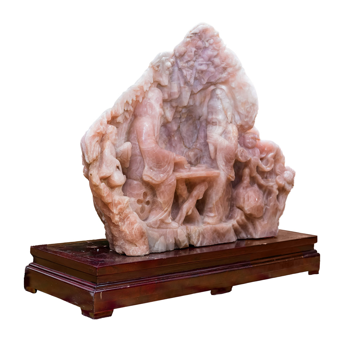 Rose quartz chess scene sculpture on wood base