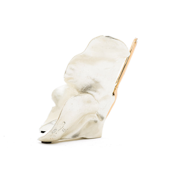 Side profile of white butterfly with golden antennae and trim