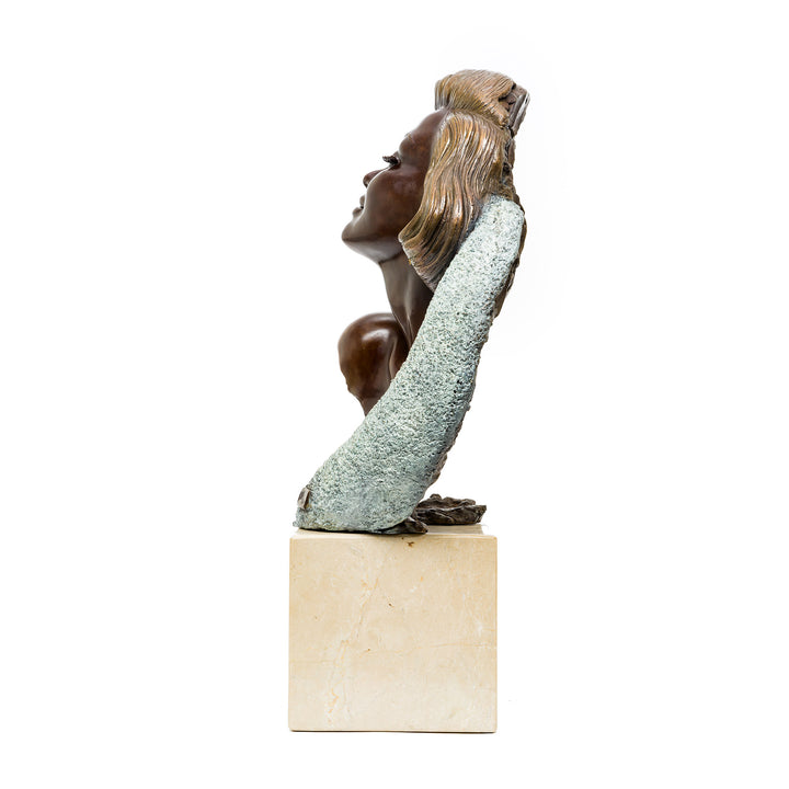 Side angle showing hair and crescent detail on sculpture