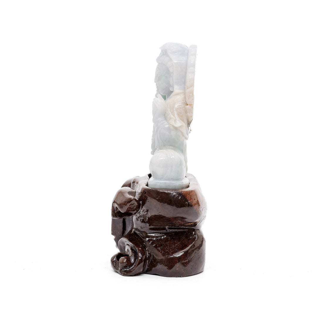 Side view of Guan Yin jade statue with leaves