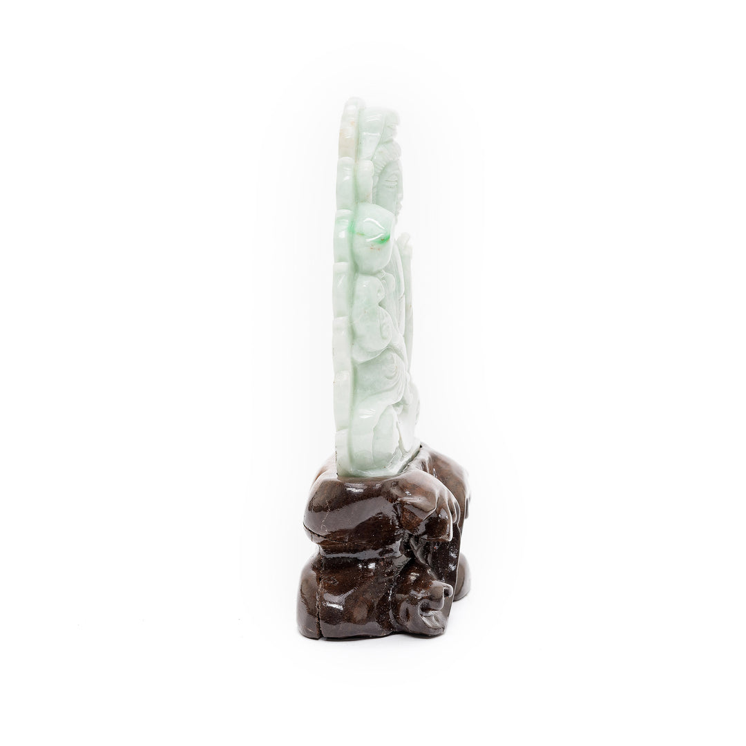 Side view of jade Guan Yin statue on stand