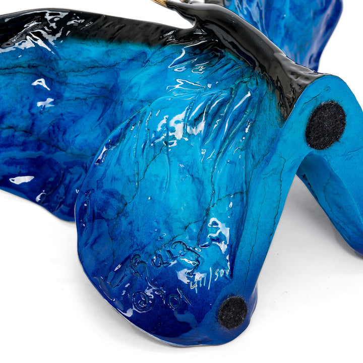 Artist signature and edition number beneath butterfly