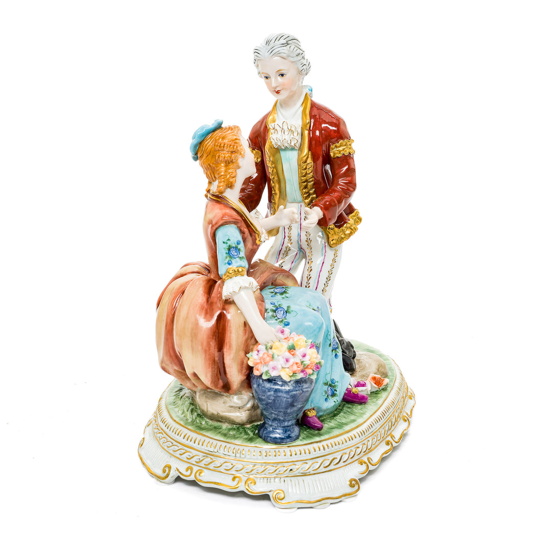 Tender proposal figurine in fine German porcelain, depicting a gentleman on one knee and a lady surrounded by flowers.