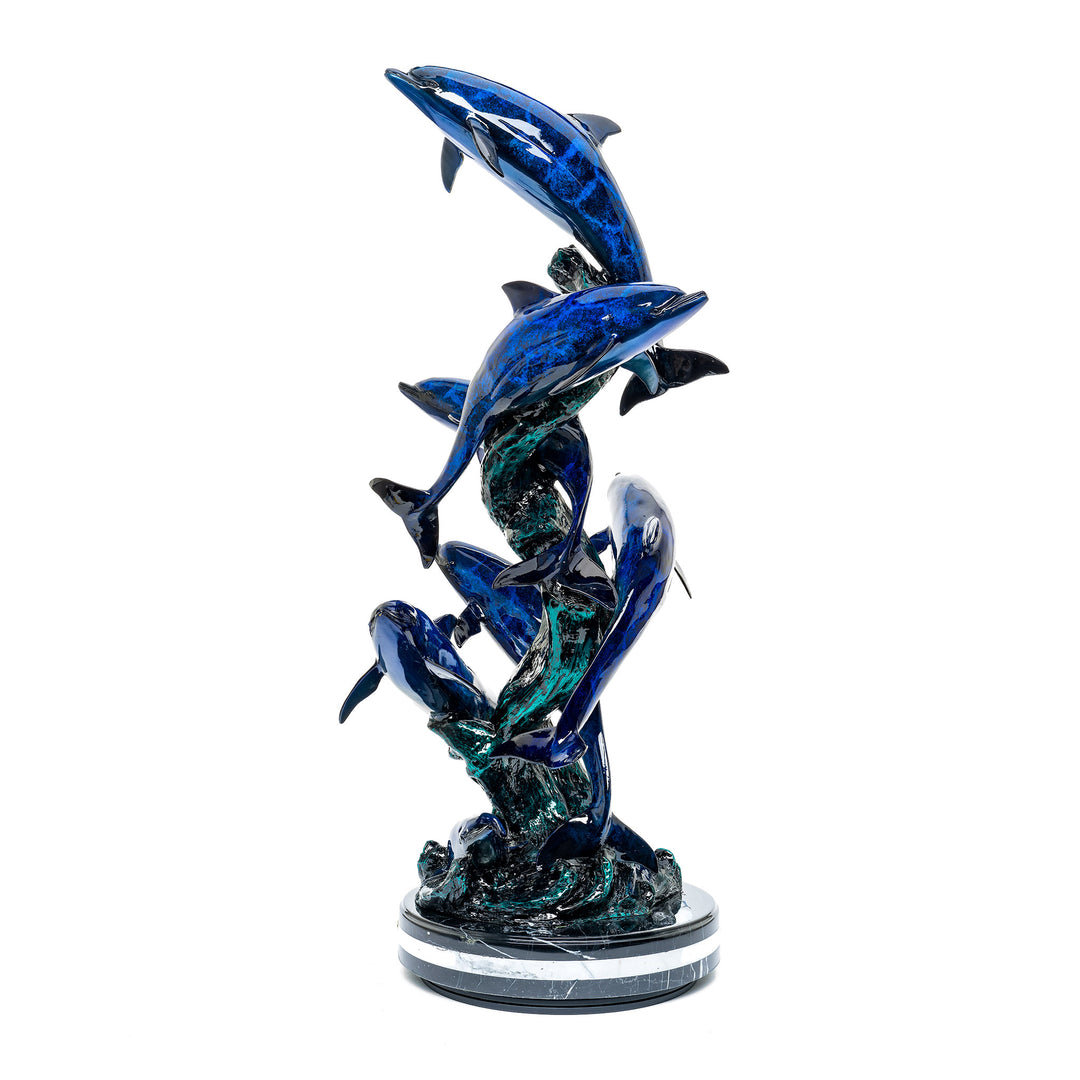 Vibrant dolphins sculpture by Muzika with dynamic patina finish.