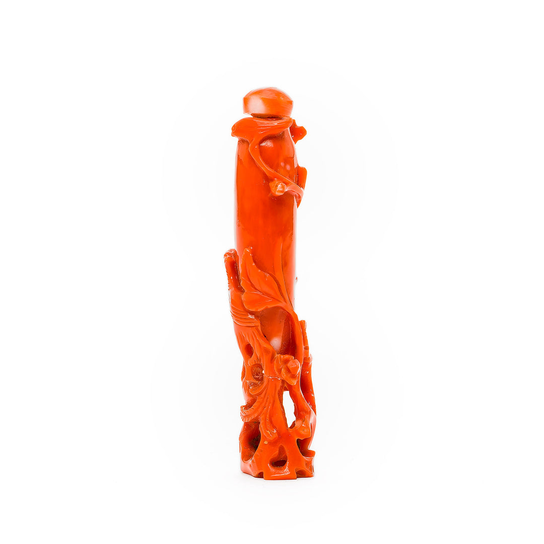 Vibrant red-orange coral bottle showcasing detailed artistry