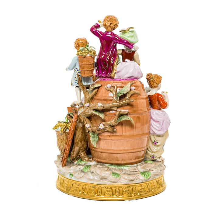 Vibrant Young Winemakers Family figurine in fine German porcelain with floral details.