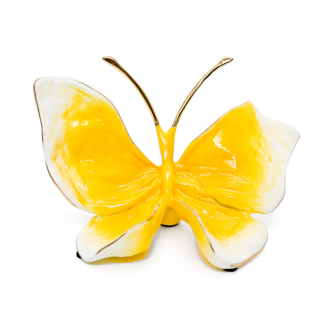 Bright yellow bronze butterfly sculpture with white tips