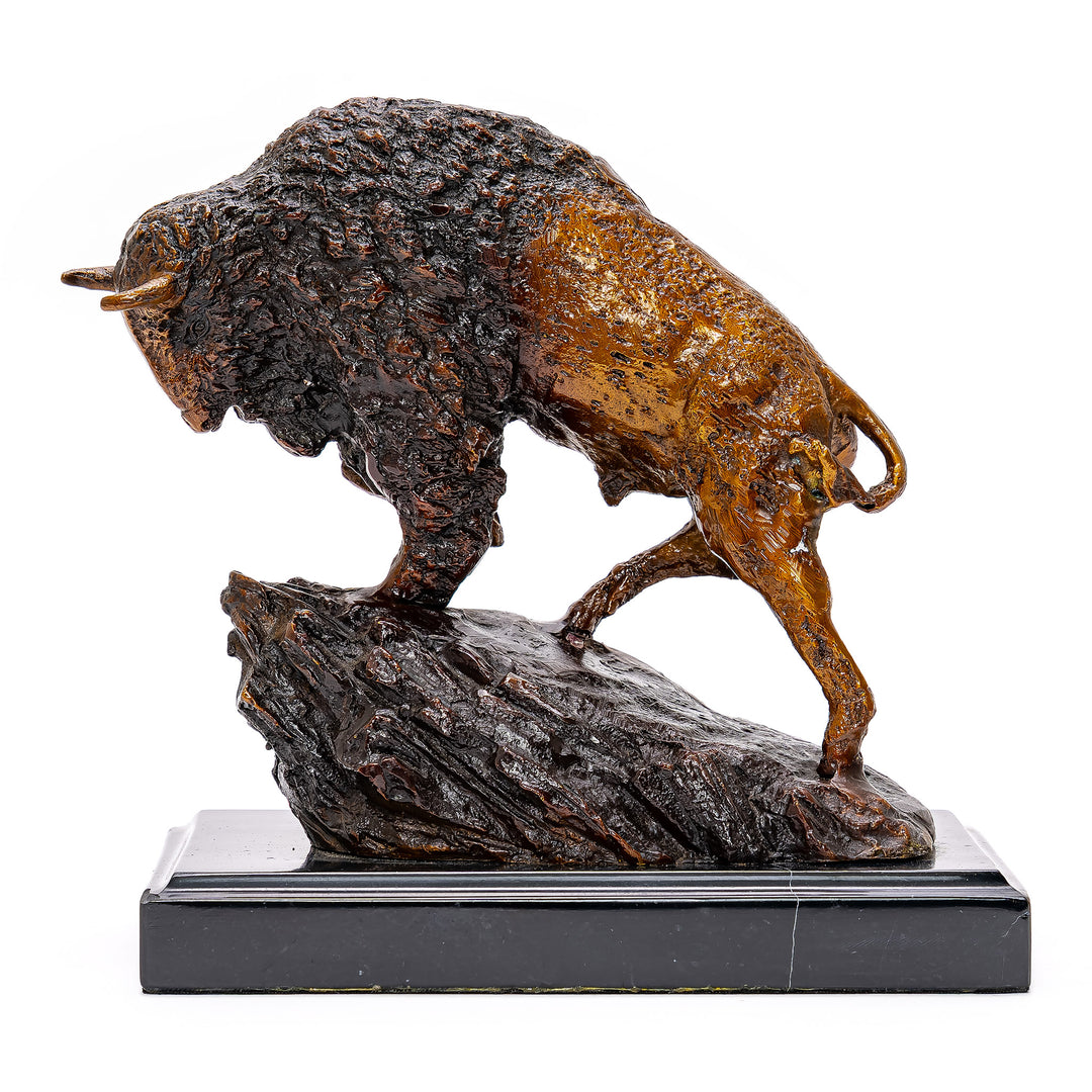 Bison on rocky ledge mounted on marble base sculpture