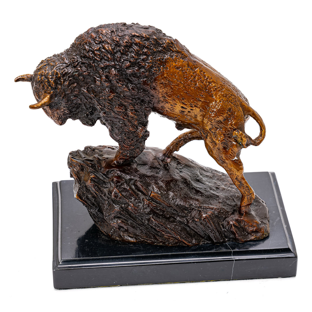 Wildlife sculpture of bison in natural setting